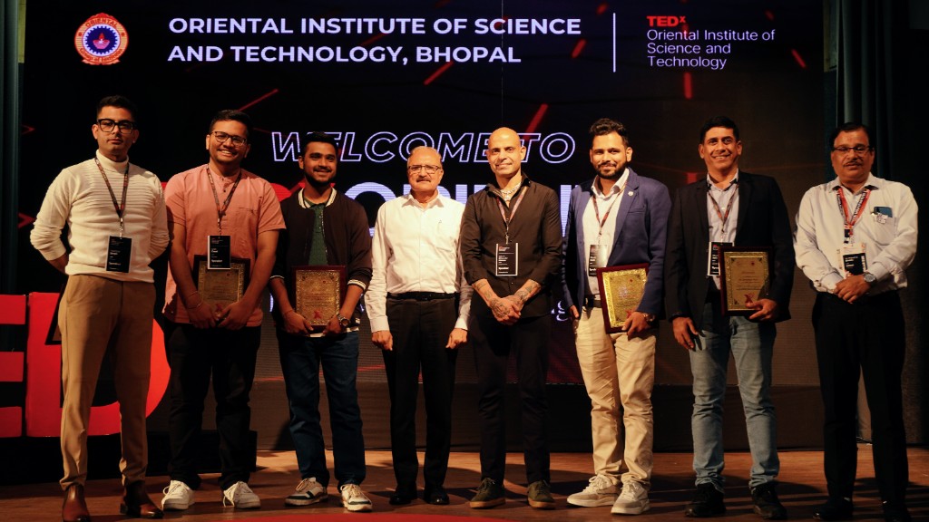 Group photo featuring Ritwik Joshi alongside other distinguished speakers from the TEDxOIST event.