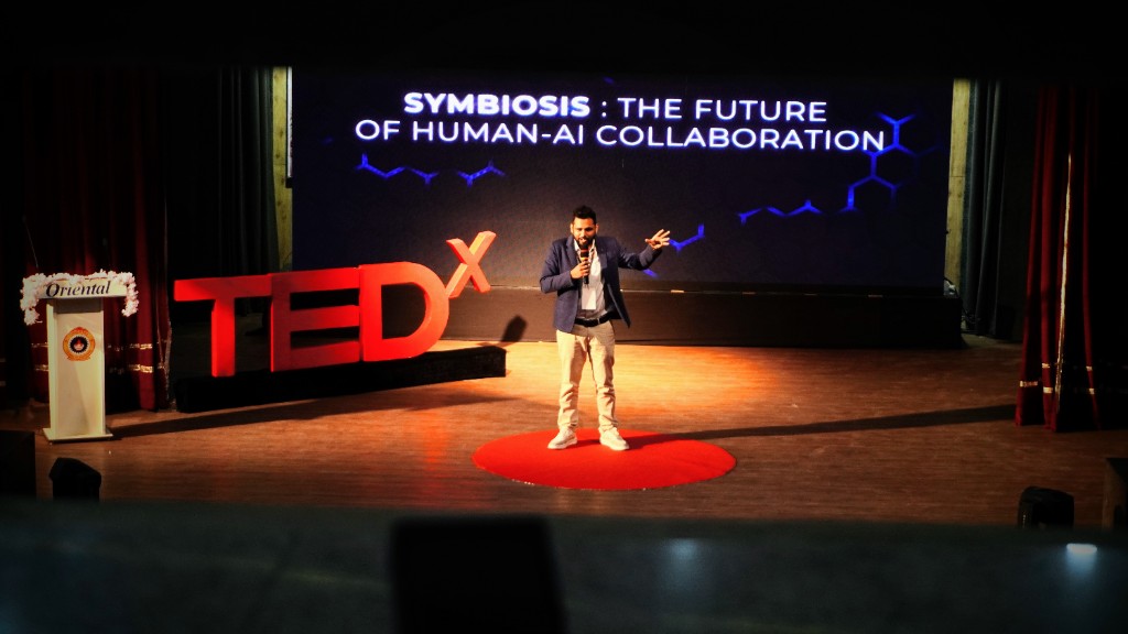 Ritwik Joshi delivering a deep-tech presentation at TEDxOIST about the symbiotic future of human-AI collaboration.